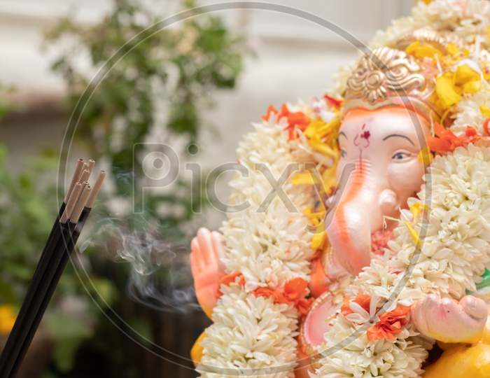 Incense Or Agarbatti Sticks In Front Of Lord Vinayaka Or Ganesha While Worshiping During Ganesha Chaturthi Or Vinayaka Festival Ceremony.