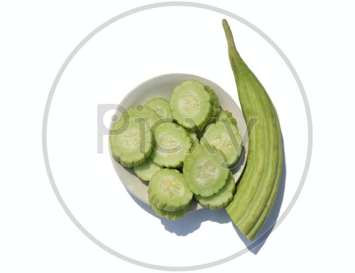 Armenian Cucumber Or Yard Long Cucumber In A Plate Isolated On White Background With Copy Space, Also Known As Kakri