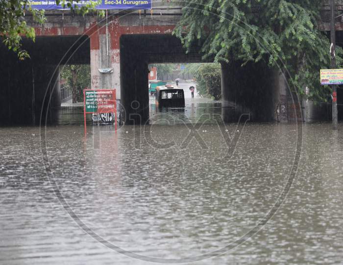 A bus stuck in a Prahladpur water-logged underpass after heavy rains in New Delhi, India, August 19, 2020.