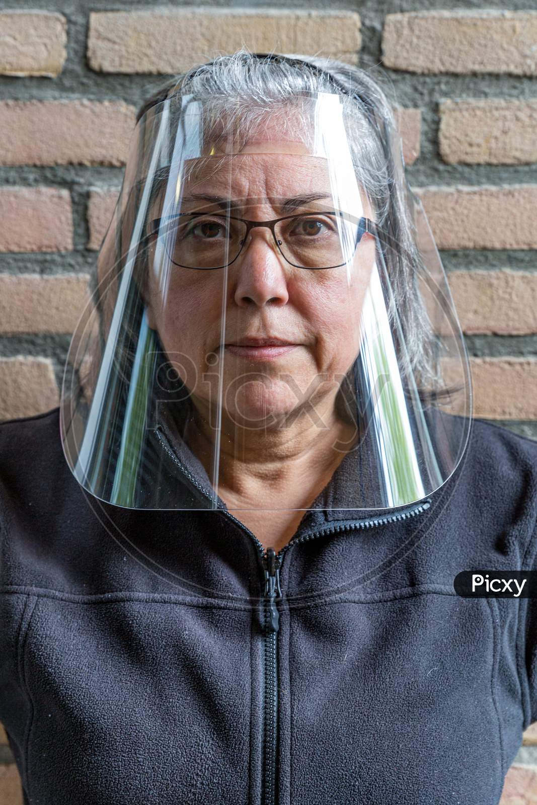 Face Shield Or Protection Medical Screen On A Mature Woman Wearing Glasses To Prevent The Spread Of Covid-19 Amid The Coronavirus Outbreak, New Lifestyle, Front View