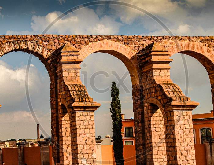 Brick And Stone Arches In An Orange Color Of An Old Bullring, Wonderful Sunny Day With A Blue Sky With White Clouds In Zacatecas Mexico