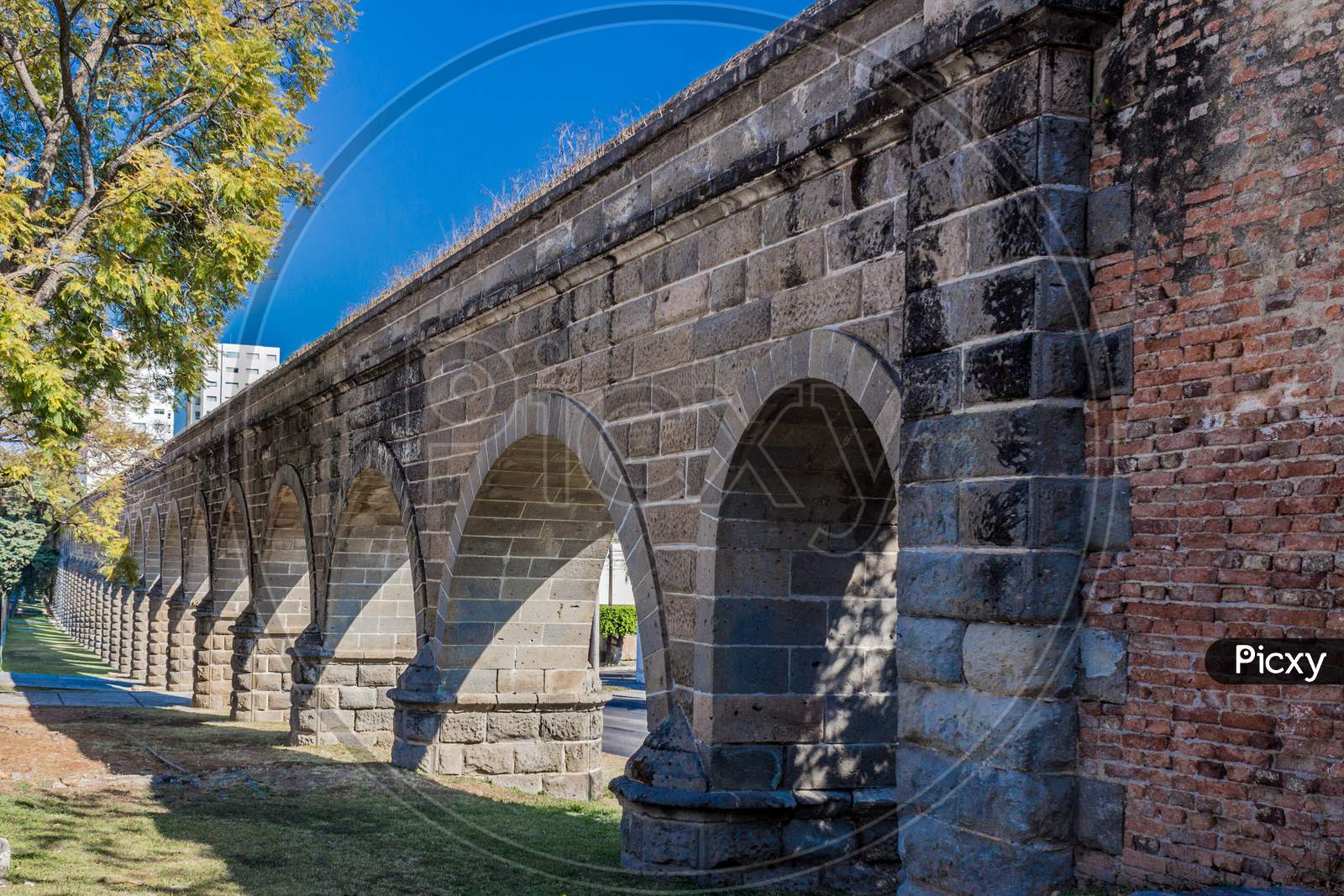 Arches Of A Stone Aqueduct On A Wonderful Sunny Day With A Blue Sky In Guadalajara Jalisco Mexico