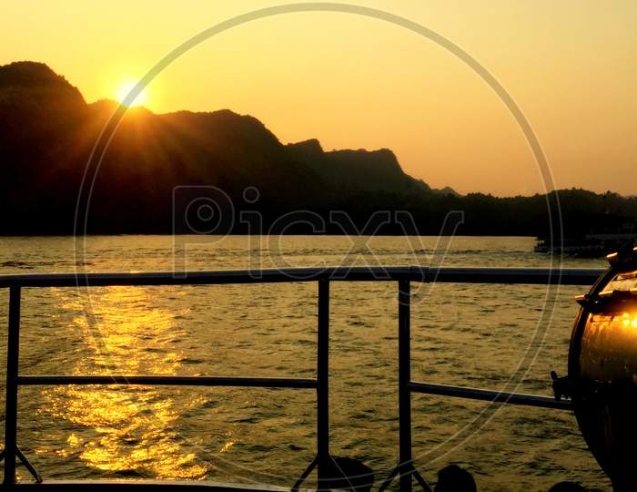 Summer Cruise Vacation Concept. Silhouette View Of The Sea With A Beautiful Sunset Just Above The Horizon.