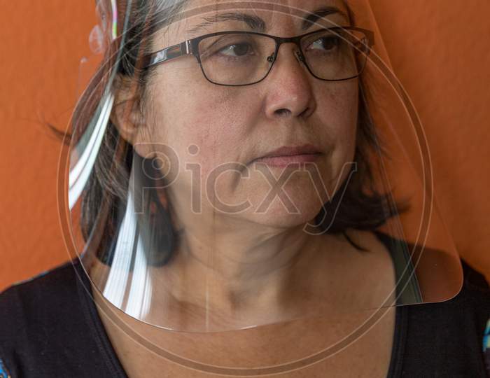 Protective Mask Or Face Shield On A Mature Woman Wearing Glasses To Prevent The Spread Of Covid-19 Amid The Coronavirus Outbreak, New Lifestyle