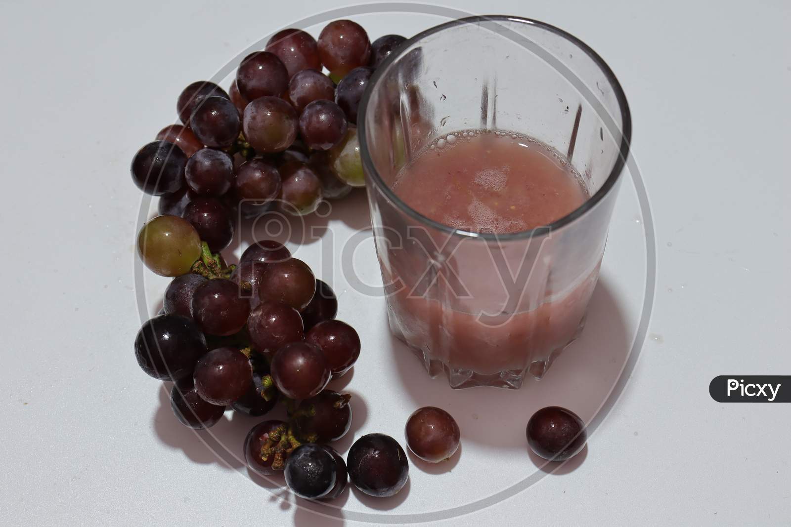Fresh Ripe black Grapes isolated on white background