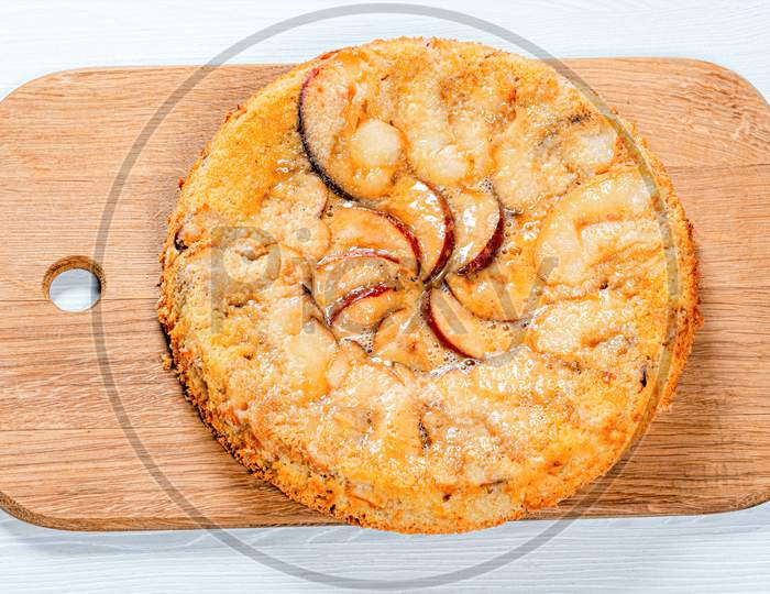 Charlotte Apple Pie On The Kitchen Board. View From Above