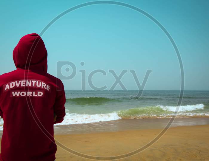 Man Facing body of ocean and trying to say the Adventure world and enjoying alone wallpaper