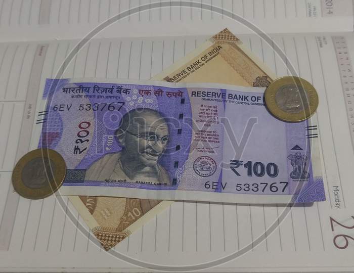 The Indian currency on opened page of diary.