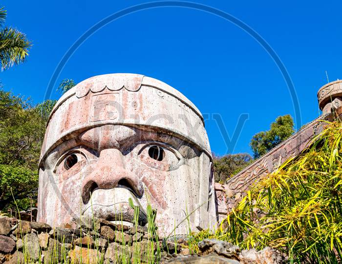 Replica Of A Toltec Head On A Sunny Day With An Intense Blue Sky In Mexico