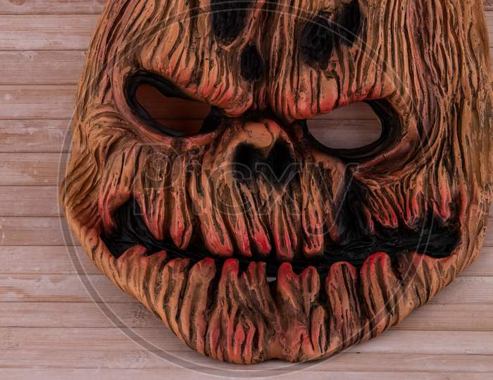 Textured Evil Pumpkin Mask On Wooden Backdrop