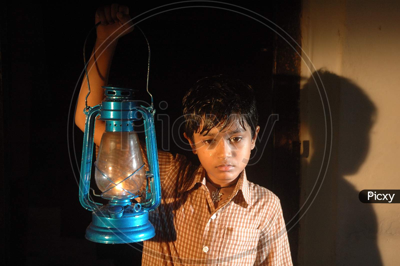 Image of Innocent Young Boy with Lantern-JQ270764-Picxy