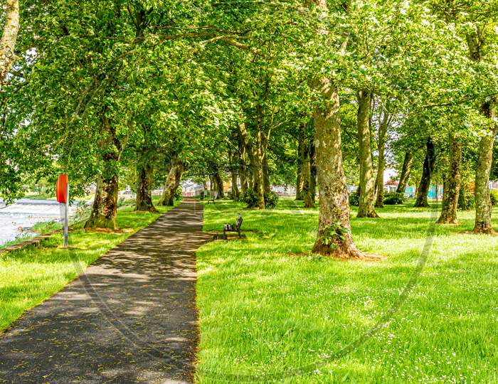 Path With Benches In A Park Next To A River In The Village Of Athlone, In The County Of Westmeath, Ireland