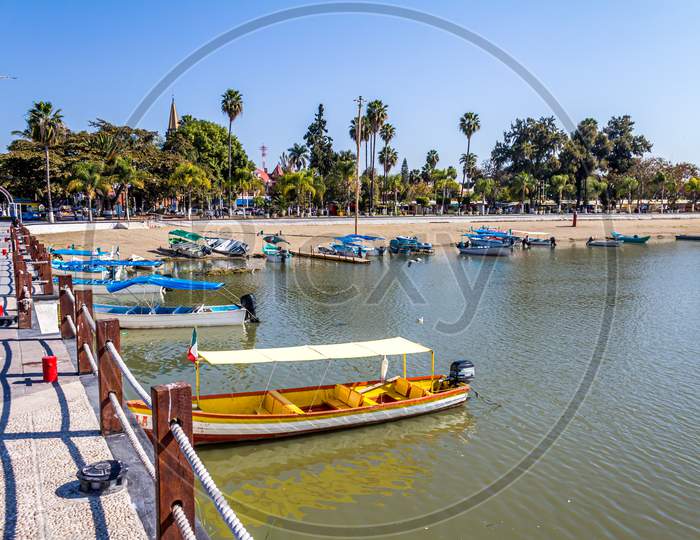 Beautiful View Of Colorful Boats On A Pier With Palm Trees In Lake Chapala Mexico On A Wonderful Sunny Day With A Blue Sky Village Of Chapala Jalisco Mexico