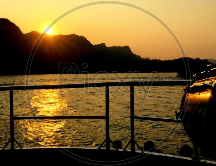 Summer Cruise Vacation Concept. Silhouette View Of The Sea With A Beautiful Sunset Just Above The Horizon.