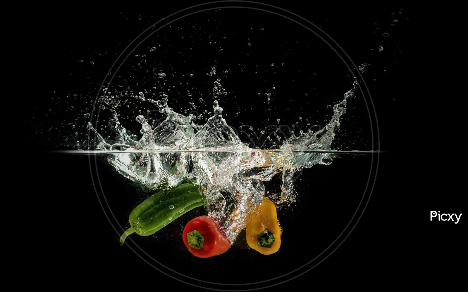 Yellow, Green & Red Bell Pepper In Water Black Background.