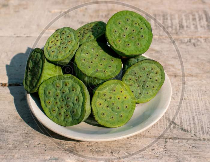 Indian Lotus Pod Or Nelumbo Nucifera Pods In A Plate On Wooden Surface