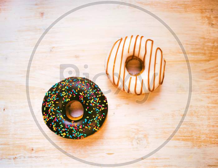 Sweet Donuts On White Wooden Background Image. Two Sweet Donut On Table.