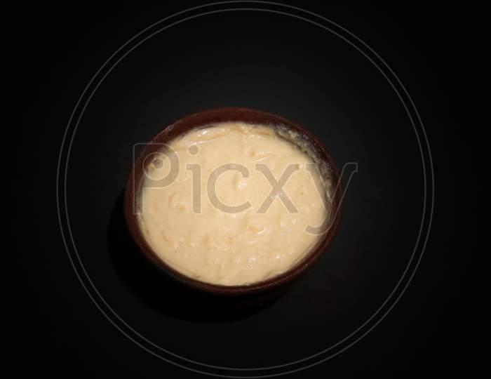 Curd Or Dahi (Yogurt) In A Soil Bowl Isolated In Black Background