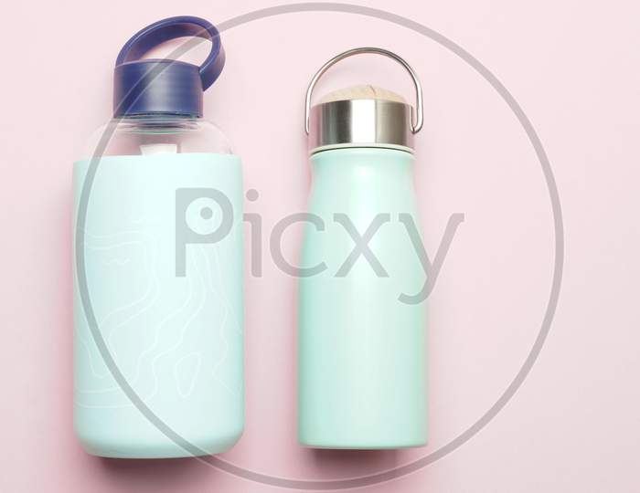 Reusable Thermos And Water Bottle On A Pink Background. Flat Lay Lat Design Zero Waste Concept