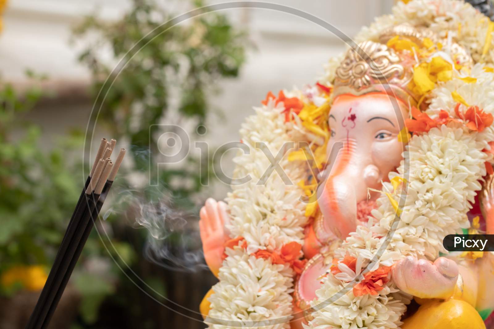 Incense Or Agarbatti Sticks In Front Of Lord Vinayaka Or Ganesha While Worshiping During Ganesha Chaturthi Or Vinayaka Festival Ceremony.