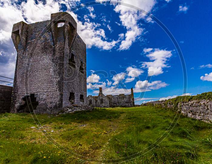 Ruined 19Th Century Tower (A Túr Faire) In Inis Oirr Island, Wonderful Sunny Day With A Blue Sky And White Clouds In Inisheer, Island In The West Of The Coast Of Ireland