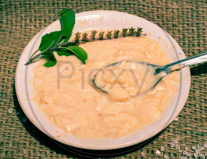 Dahi Or Curd With Spoon And Basil Leaves In A Plate With Selective Focus