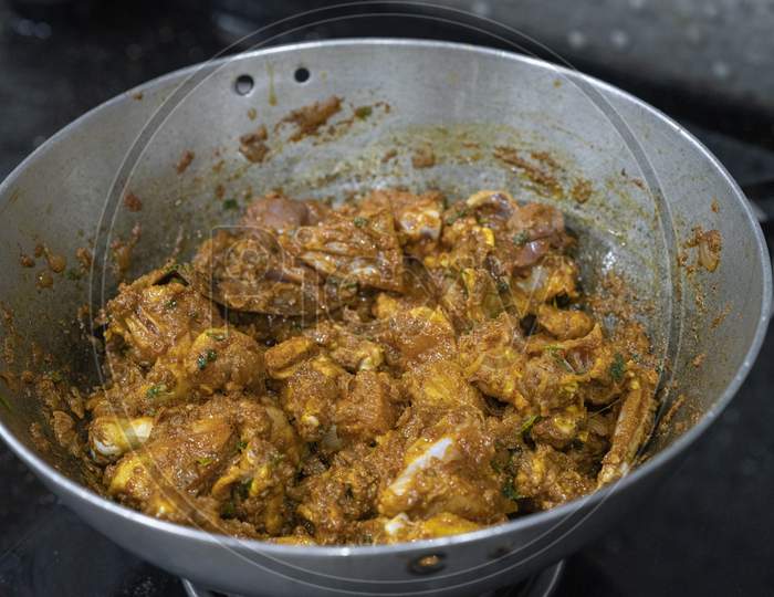 Closeup of chicken curry in a metal pot