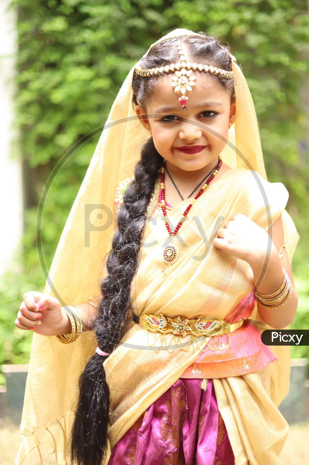 Cute little girl dressed in traditional Indian sari