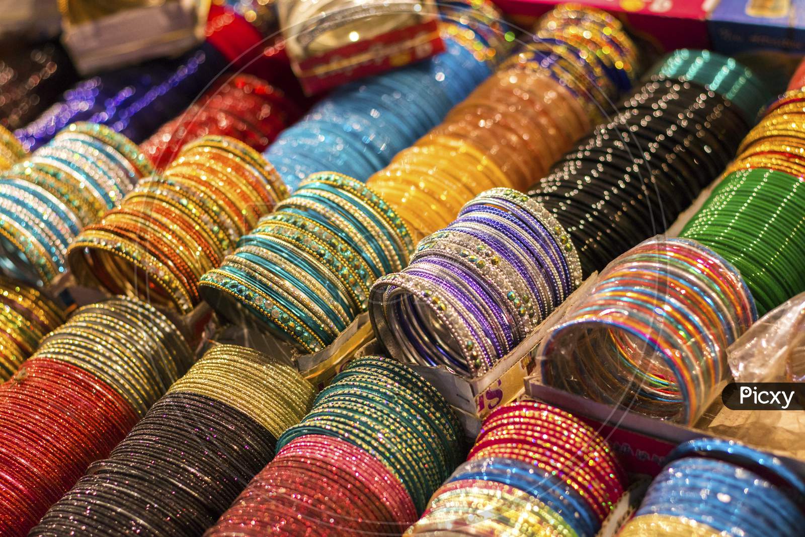 Multi-Colored Indian Glass/Metal Bangles Arranged On The Shelf For Sale