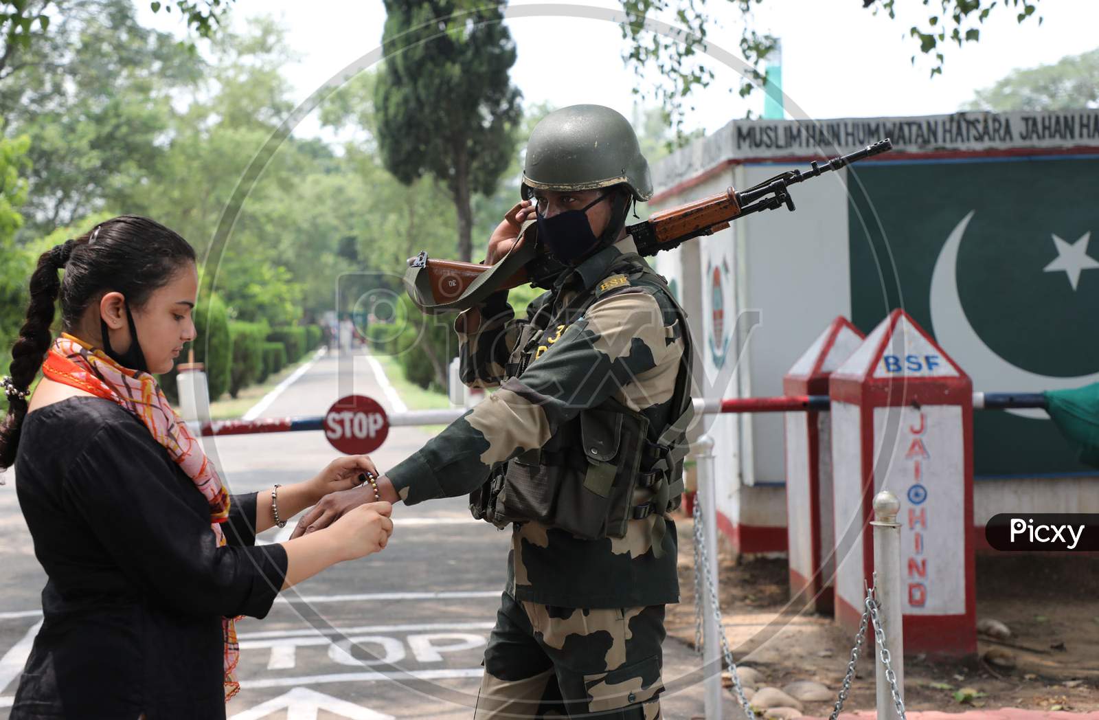 A girl ties a Rakhi on the wrist of Border Security Force (BSF) personnel at the international border Octroi post in Suchetgarh, Jammu, on August 2, 2020.