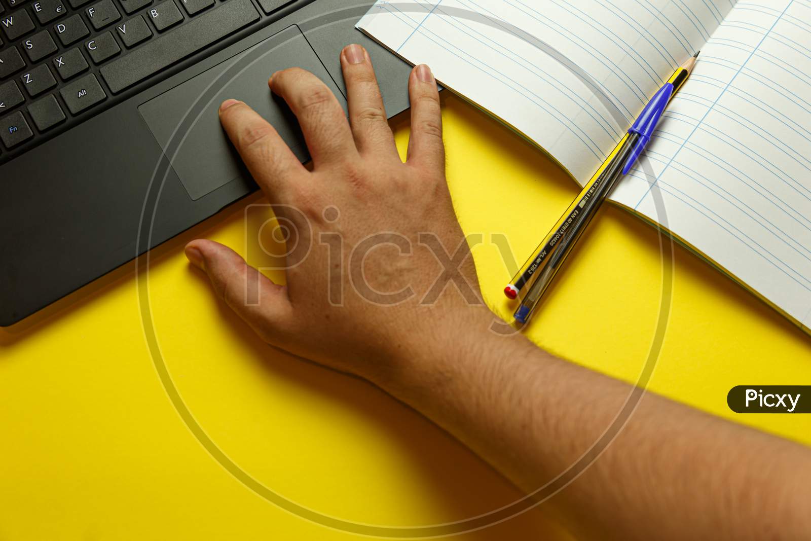Point Of View Of A Young Hand Scrolling On The Laptop While Studying