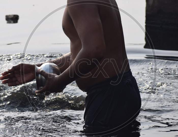 Delhi, India - Dec 31, 2019 : Man Taking Bath In Holy River Of Yamuna During Morning Time In Delhi India, People Taking Holy Dip Inside Yamuna River