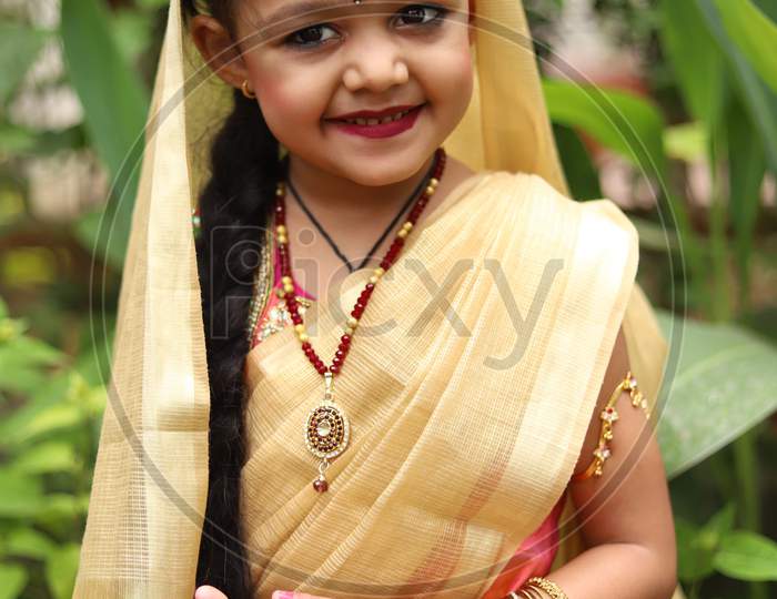 Cute little girl dressed in traditional Indian sari