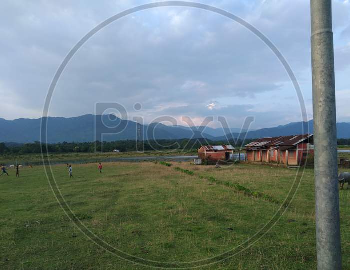 Nature . Mountains background with cloudy sky . Village school.