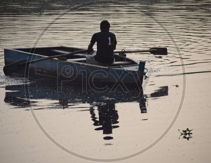 New Delhi, India - March 04, 2020: A Man Paddling A Boat During Morning Time At Yamuna River Ghat In New Deli, India
