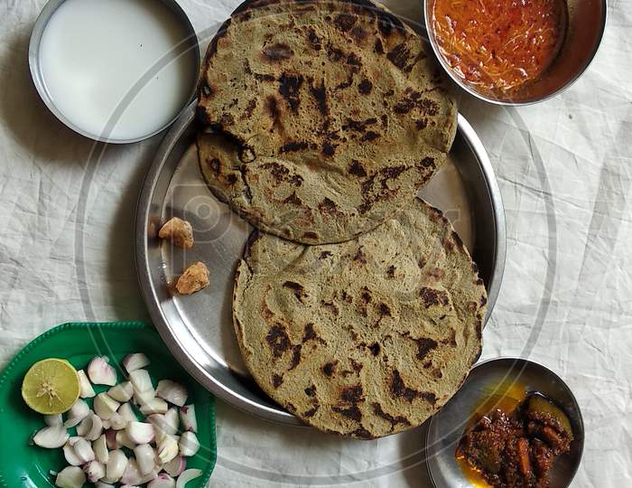 Gujarati Food. Bajra Rotlo with sev  Tomato Vegetable, along with Mango Pickle, Jaggery, Lemon, Onion Salad.2 Aug 2020