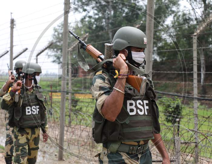 BSF personnel patrol at the international border Octroi post in Suchetgarh, Jammu, on August 2, 2020.