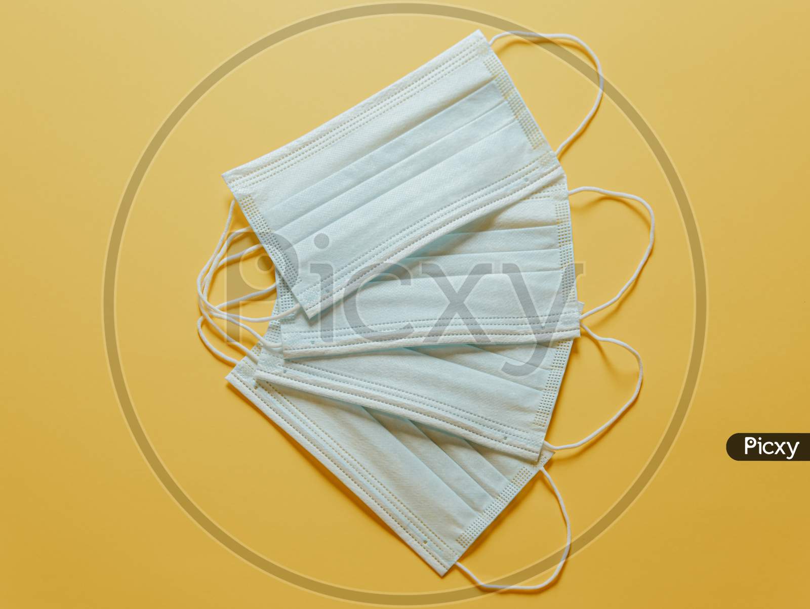 Bunch Of Surgical Masks Over A Pastel Yellow Background