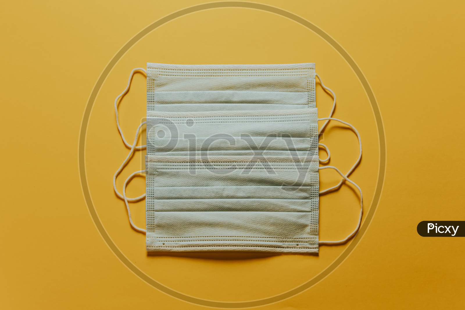 Bunch Of Medical Masks Over A Yellow Background