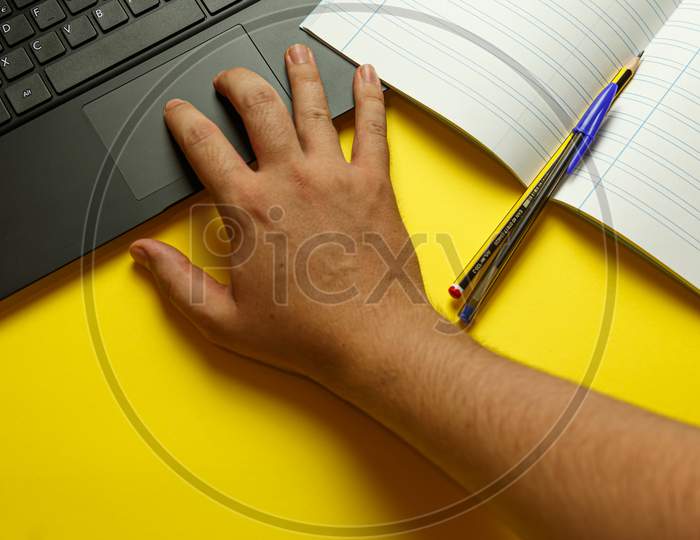 Point Of View Of A Young Hand Scrolling On The Laptop While Studying