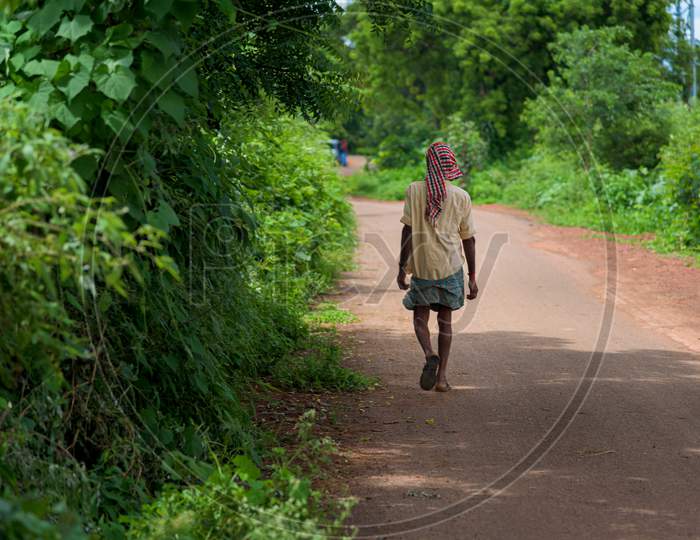 Farmer walking on road near shankarpally