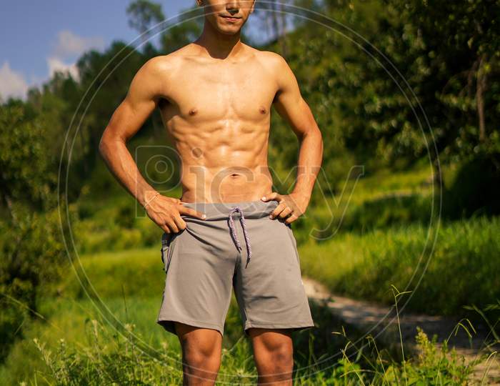 image-of-young-handsome-shredded-boy-standing-shirtless-on-the-pathway-fitness-and-health