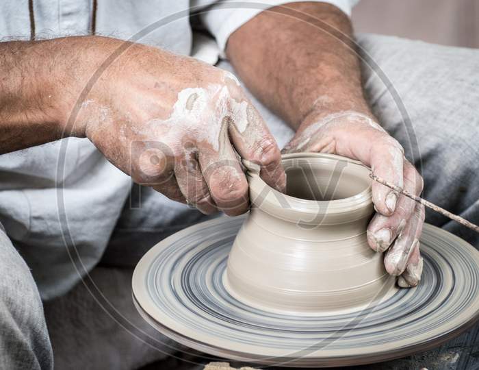 A Man Is Making Clay Art By His Hand