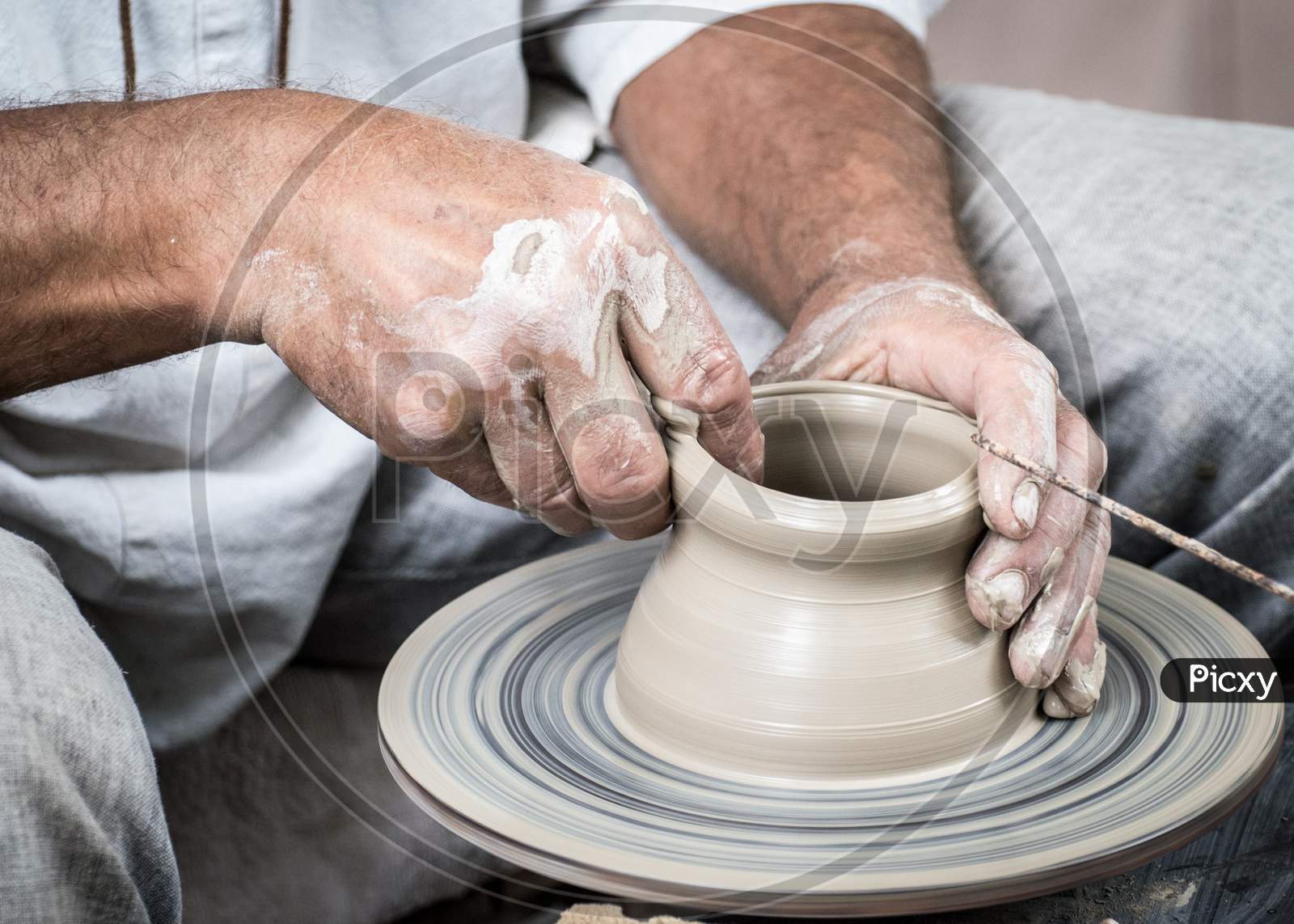 A Man Is Making Clay Art By His Hand