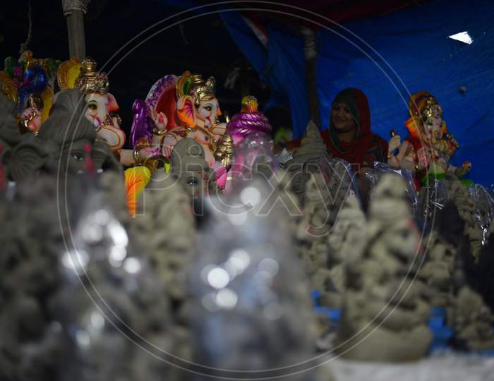 A vendor waits for customers to sell the Idols of hindu deity, Lord Ganesh ahead of Ganesh Chaturthi festival in Hyderabad, August 21, 2020.