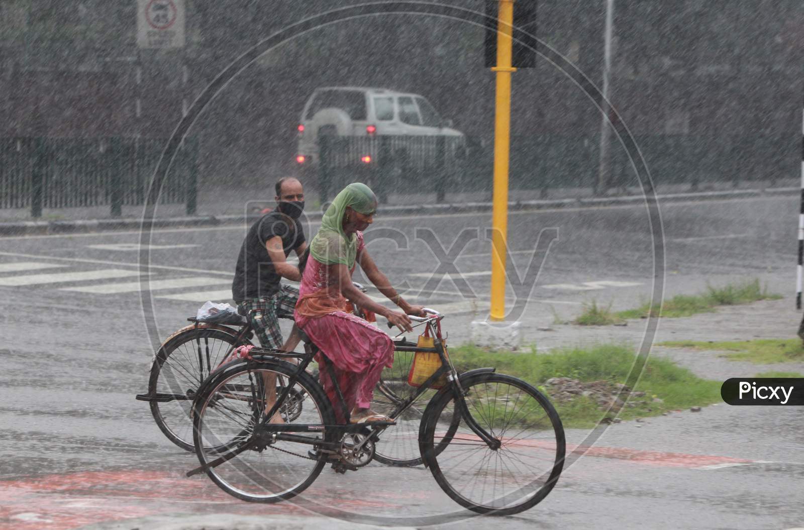 Commuters move during heavy rain in Chandigarh August 21, 2020