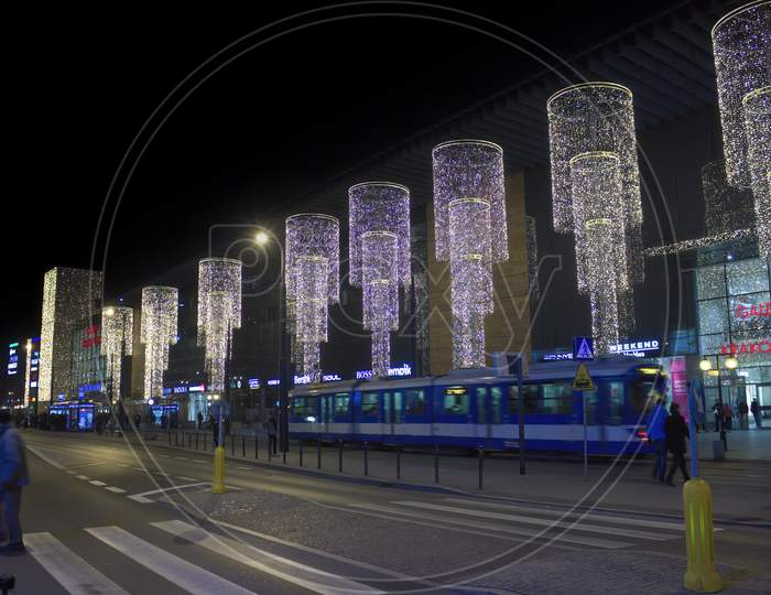 Krakow, Poland - November 30, 2014: Wide Angle View Of Decorated Shopping Mall During Christmas Holidays And A Public Tram In Motion Blurred