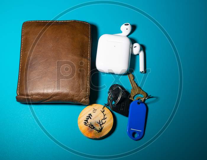 A Wallet, Airpods And Keys Left In Beautiful Background