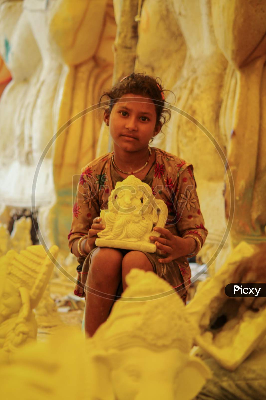 Kids crafting the Lord Ganesh idol