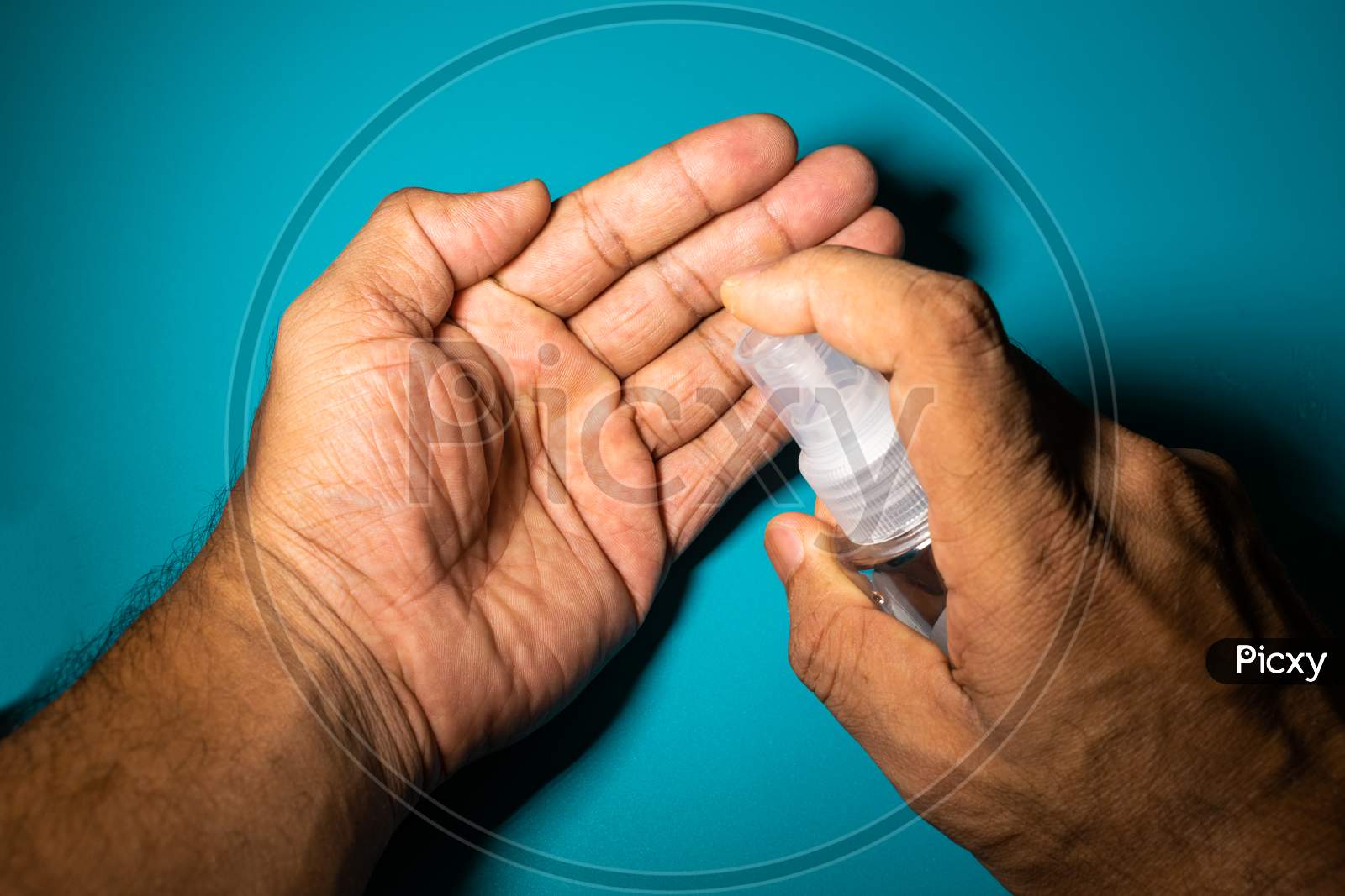 A Man Cleaning His Hand With Sanitizer To Prevent From Corona Virus, Covid 19